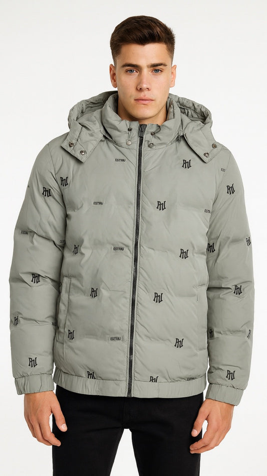 Man wearing a gray puffer jacket with brand logos on a white background