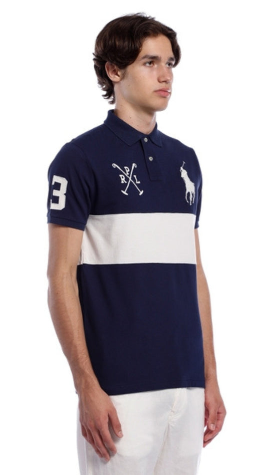 Man wearing a navy and white striped polo shirt with a logo on a white background