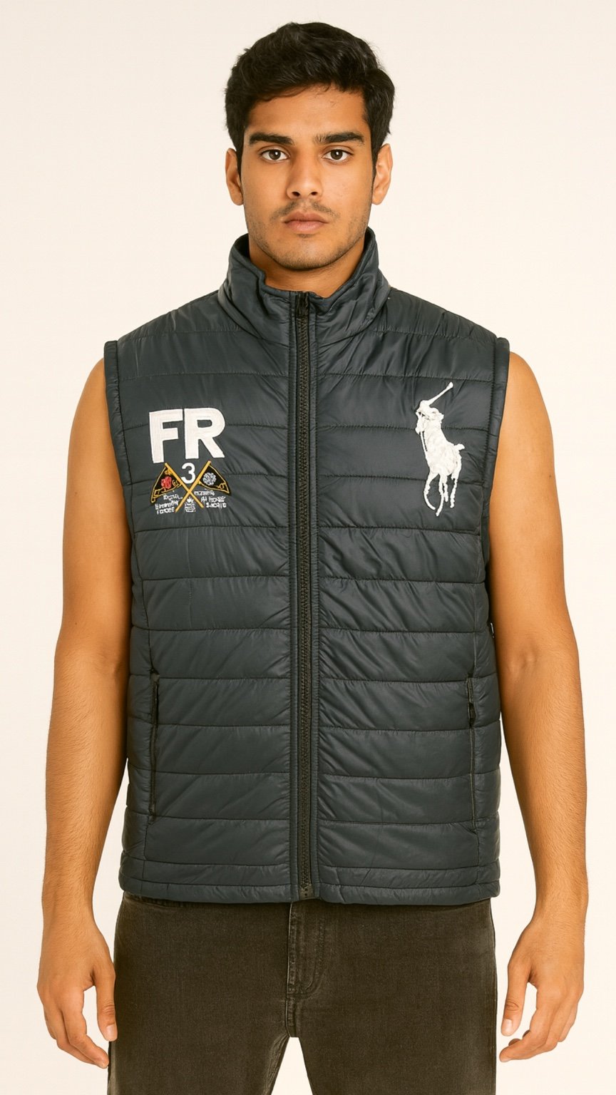 Man wearing a black puffer vest with a logo on a beige background