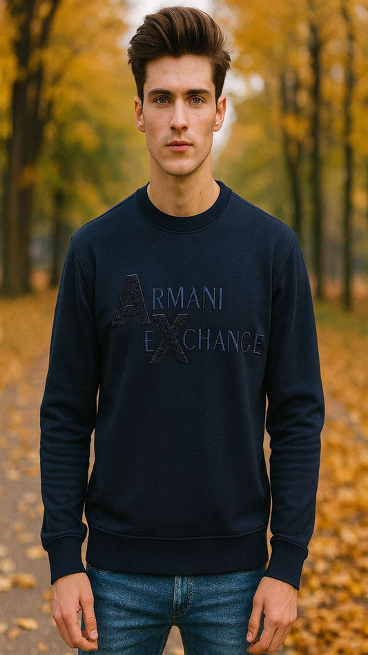 Man wearing a navy Armani Exchange sweatshirt in an autumn setting