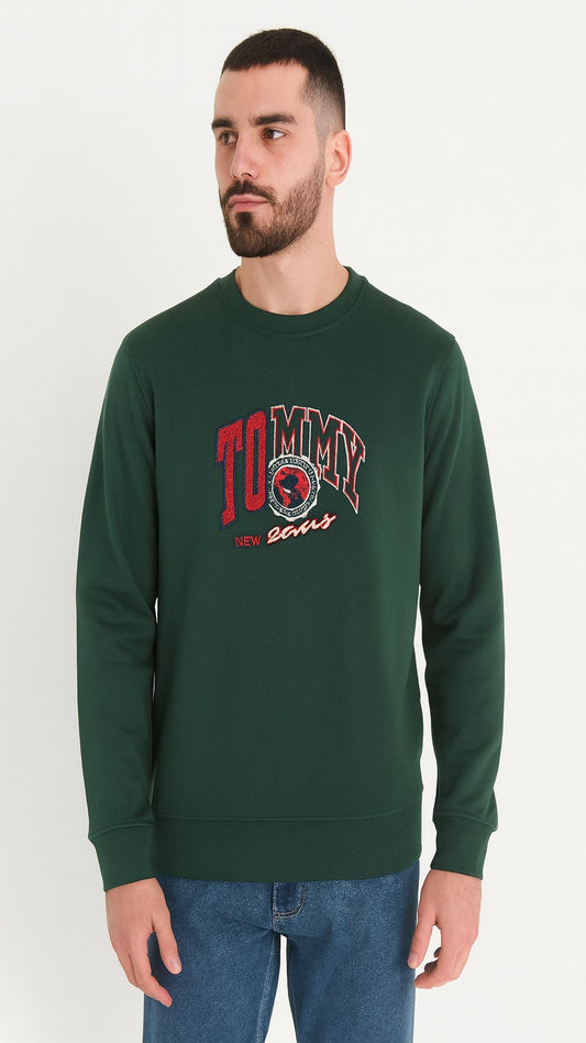 Man wearing a green sweatshirt with a logo on a white background