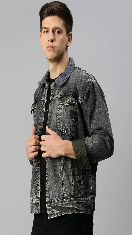 Man wearing a gray denim jacket on a gray background