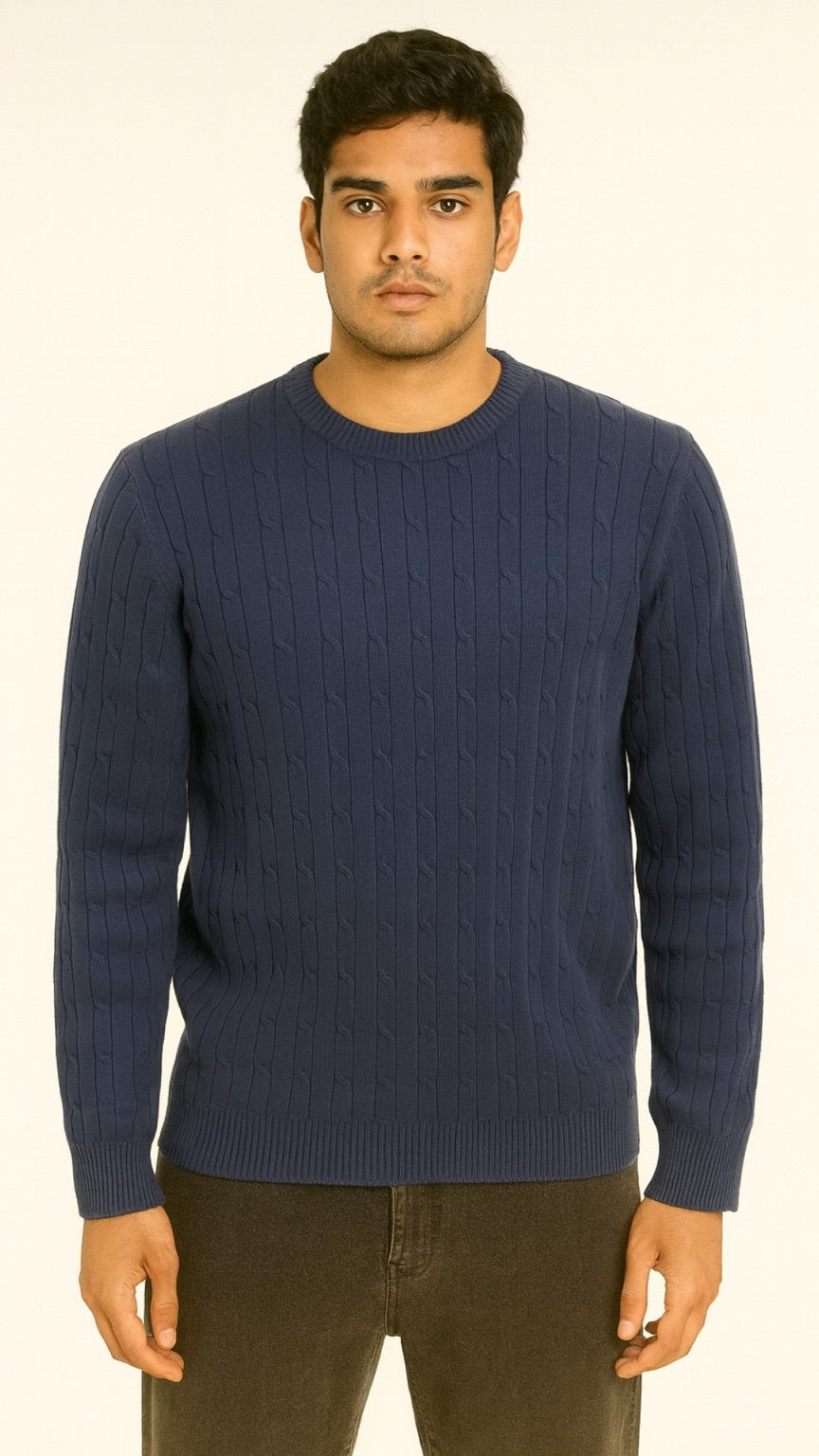 Man wearing a blue sweater against a white background