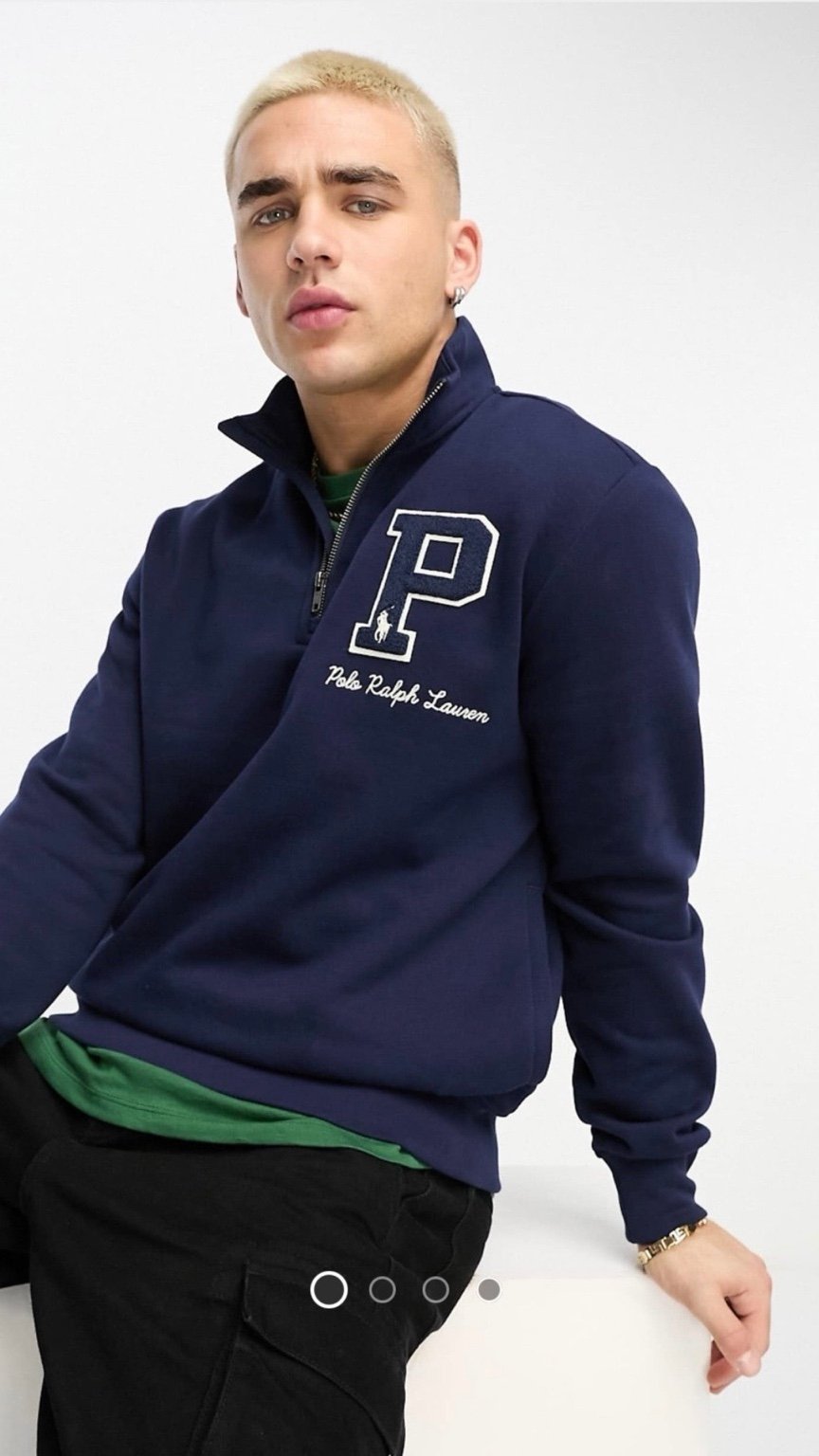 Man wearing a navy blue Ralph Lauren sweatshirt with a large 'P' logo on a white background