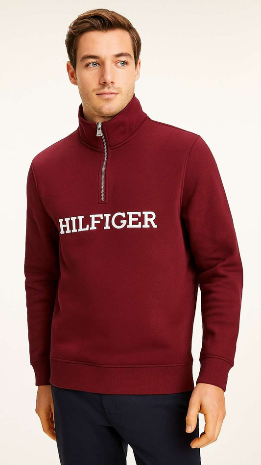 Man wearing a burgundy Tommy Hilfiger sweatshirt on a white background