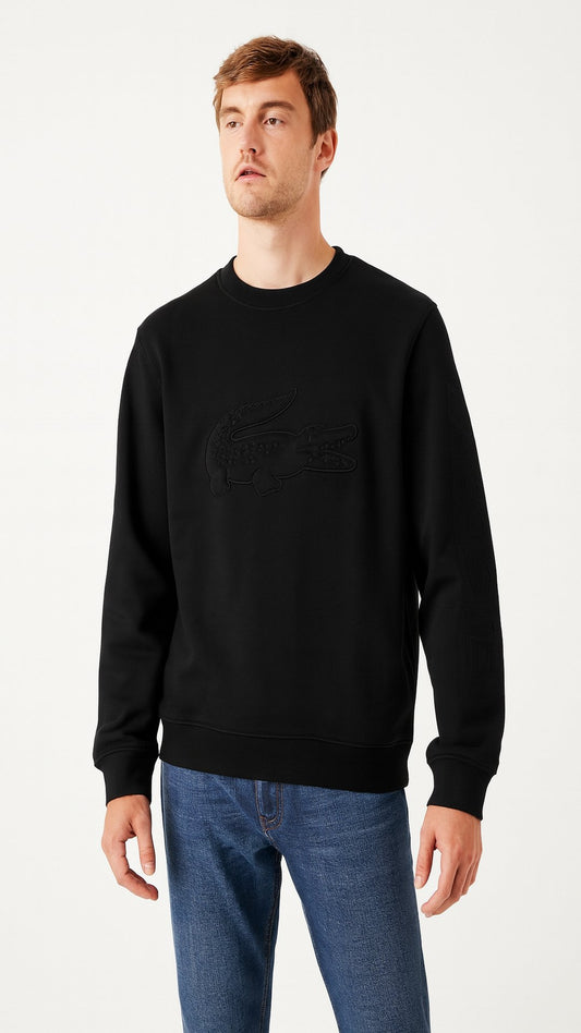 Man wearing a black sweater and blue jeans on a white background