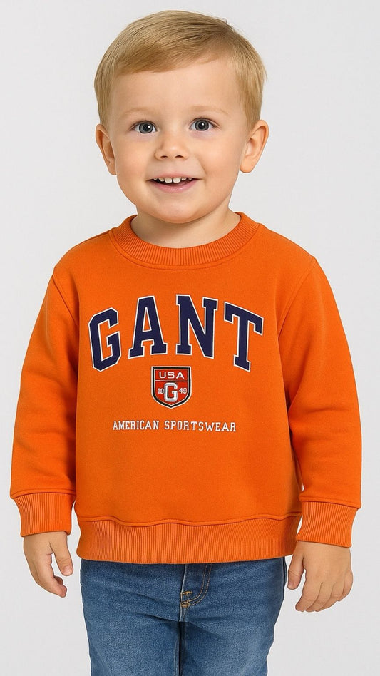 Child wearing an orange GANT sweatshirt on a white background