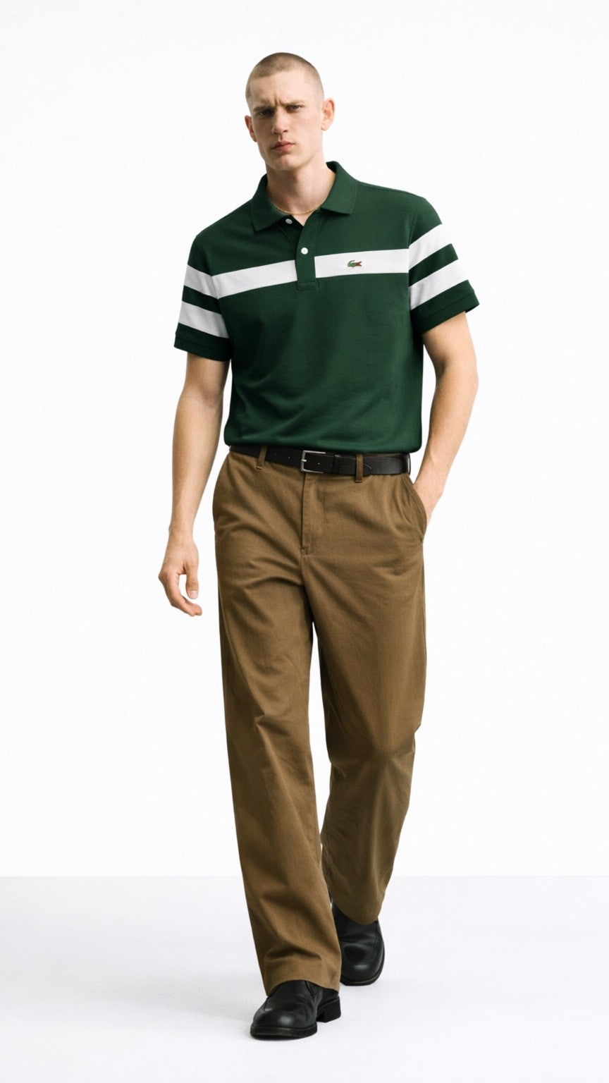 Man wearing a green polo shirt with white stripes and brown pants on a white background
