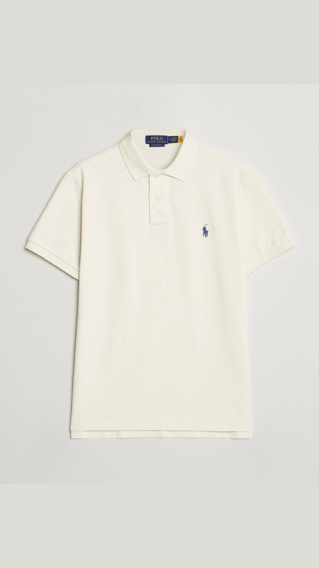 White polo shirt with a small logo on a light gray background