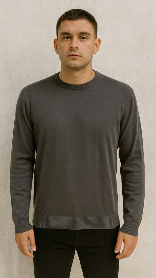 Man wearing a gray sweater against a beige background