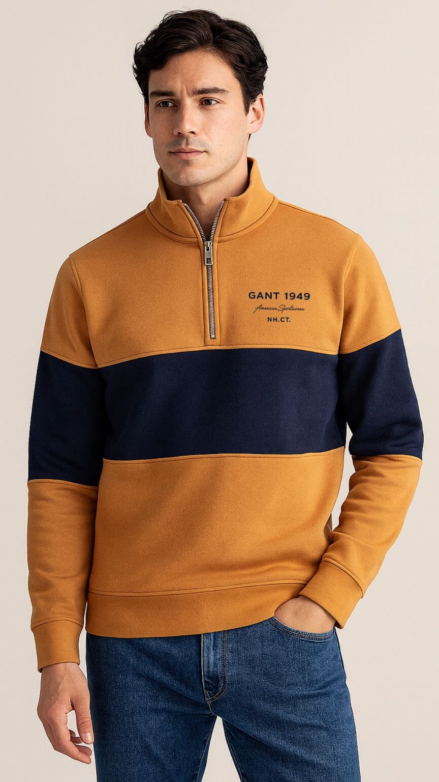 Man wearing a mustard and navy color-blocked sweater with 'Gant 1949' branding.
