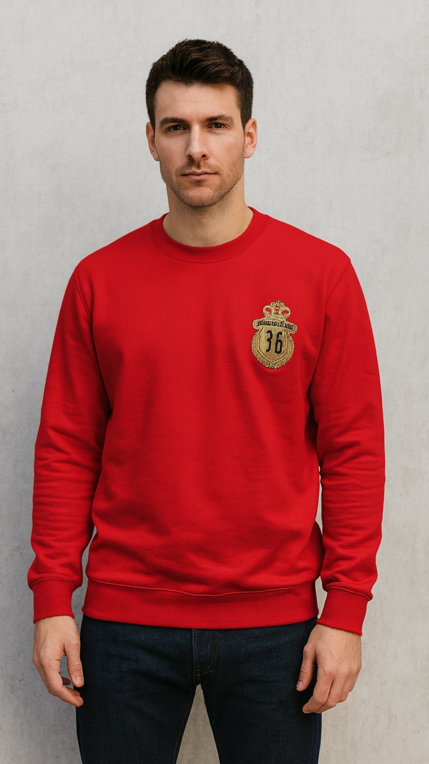 Man wearing a red sweatshirt with a logo on a gray background