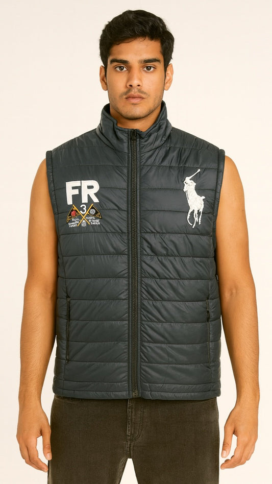 Man wearing a black puffer vest with a logo on a beige background