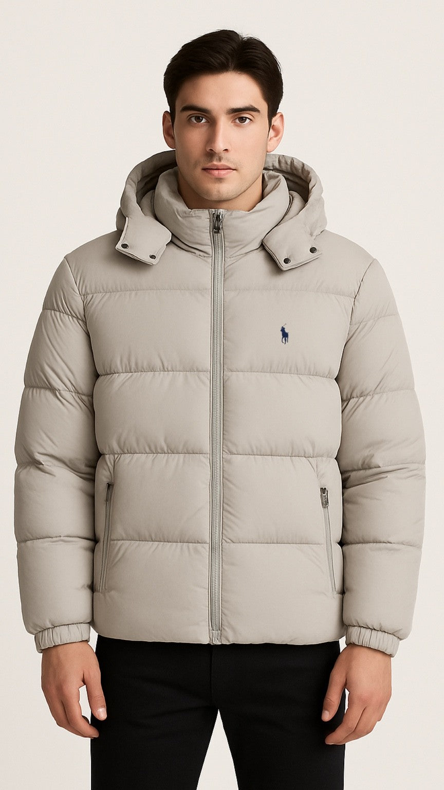 Man wearing a beige puffer jacket with a brand logo on a light background