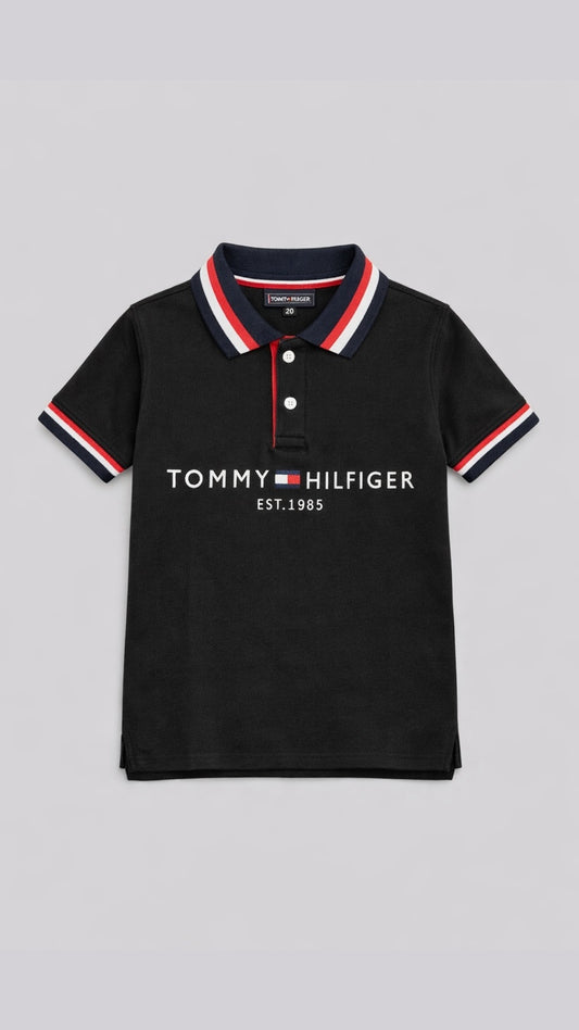 Black Tommy Hilfiger polo shirt with red and white trim on a light gray background
