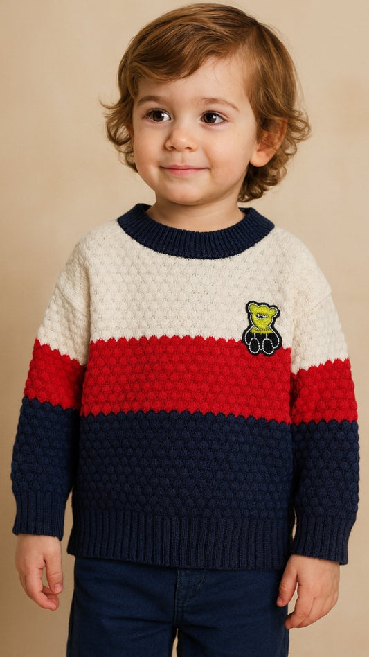 Child wearing a colorful sweater with a bear emblem on a beige background