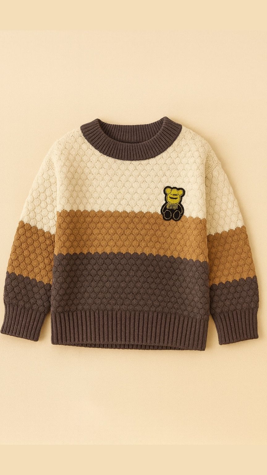 Color-blocked sweater with a teddy bear emblem on a beige background