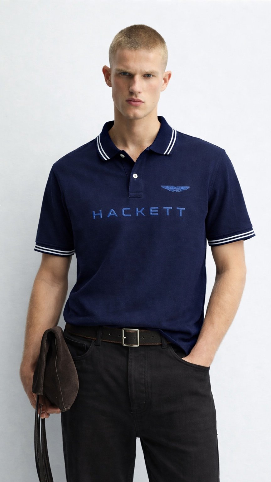 Man wearing a navy Hackett polo shirt against a white background