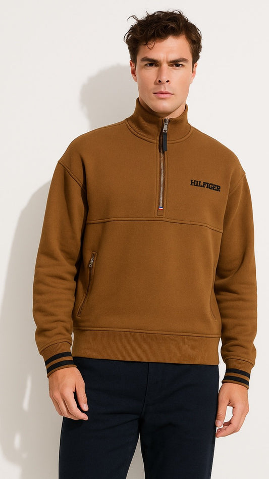 Man wearing a brown sweater with a brand logo on a white background