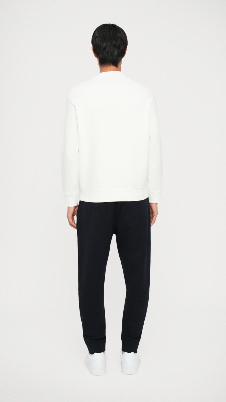 Person wearing a white long-sleeve shirt and black pants on a white background