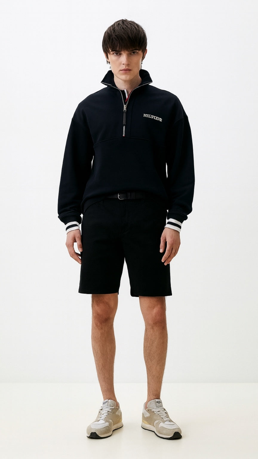 Person wearing a black outfit with a logo on a white background