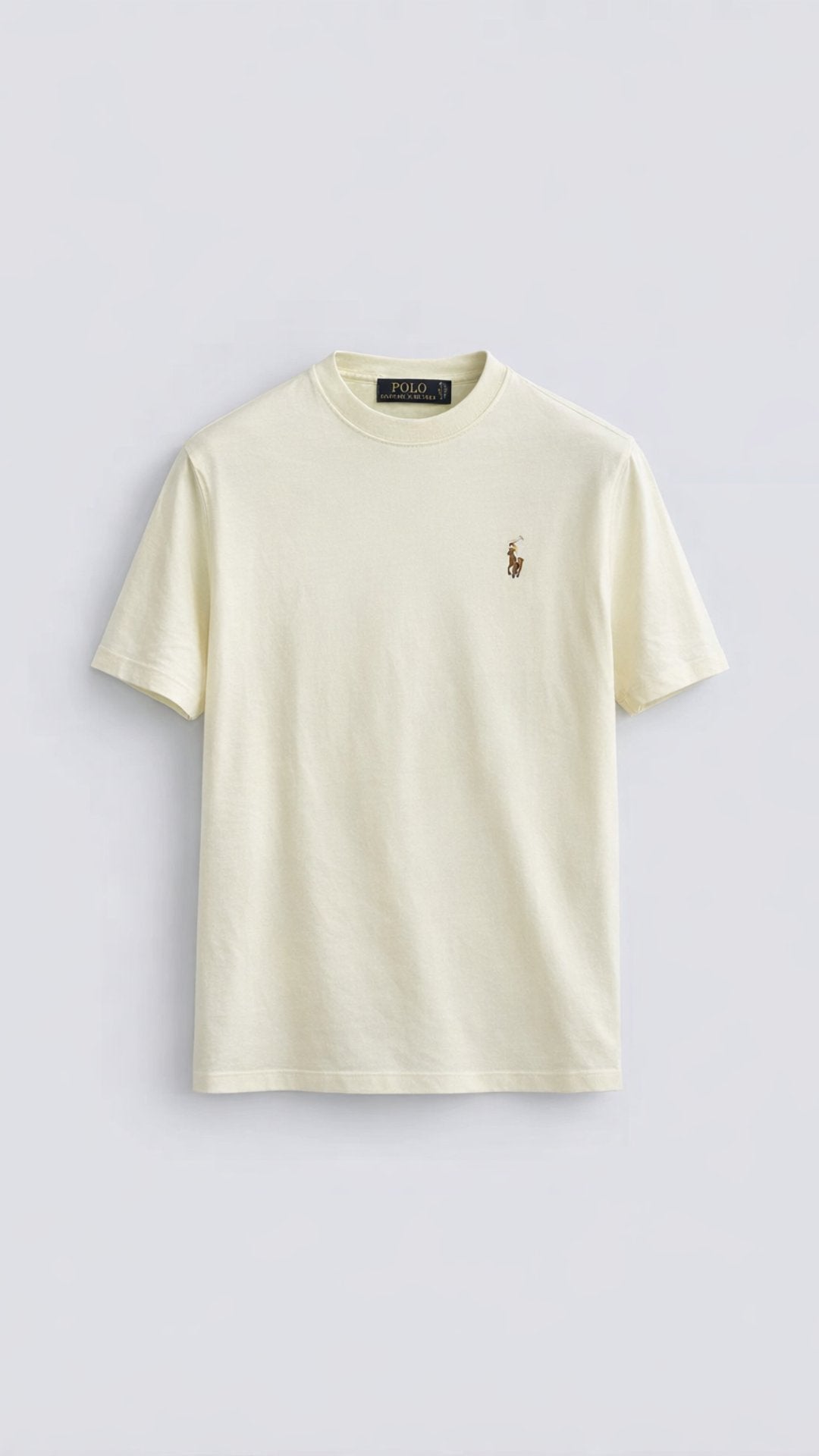 Beige t-shirt with a small logo on a light gray background