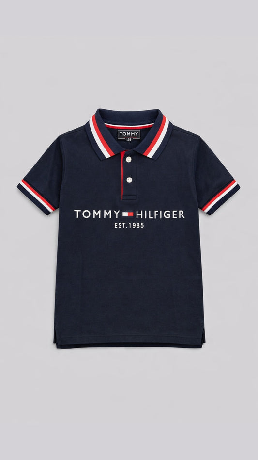 Navy Tommy Hilfiger polo shirt with red and white trim on a gray background