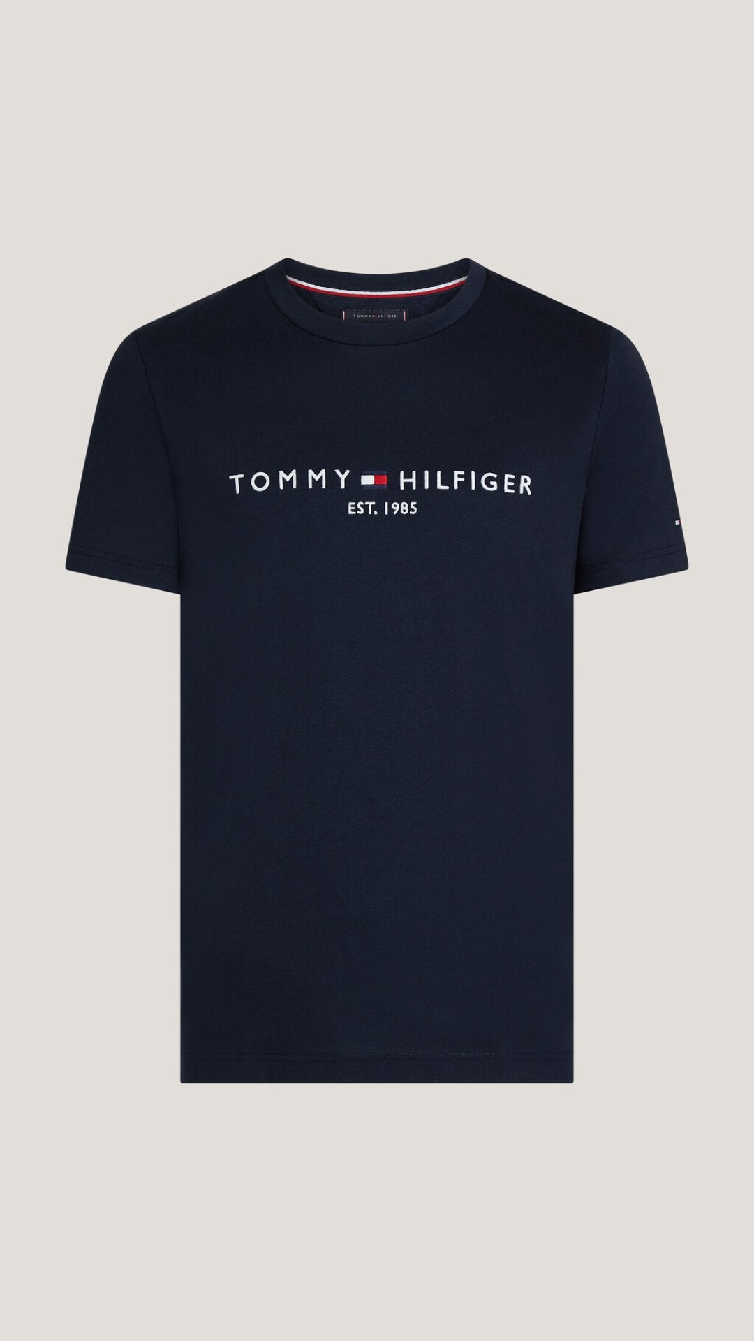 Navy blue Tommy Hilfiger t-shirt on a light gray background