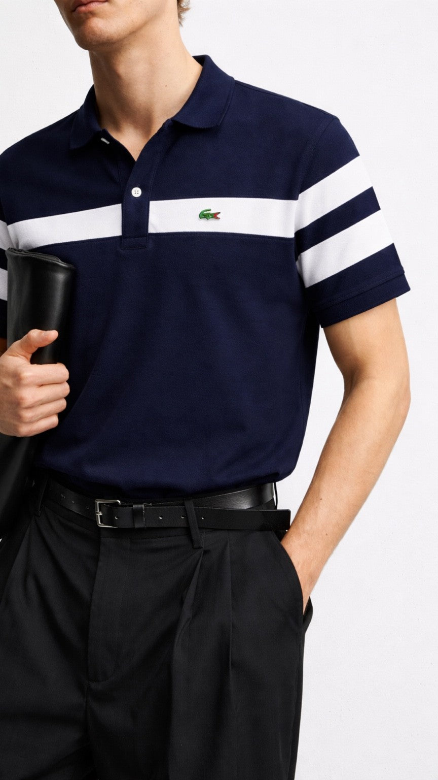 Navy polo shirt with white stripes and a visible brand logo, worn by a person.