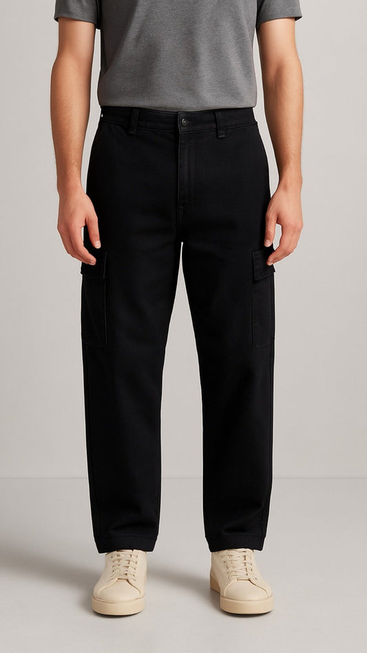 Person wearing black cargo pants on a plain background