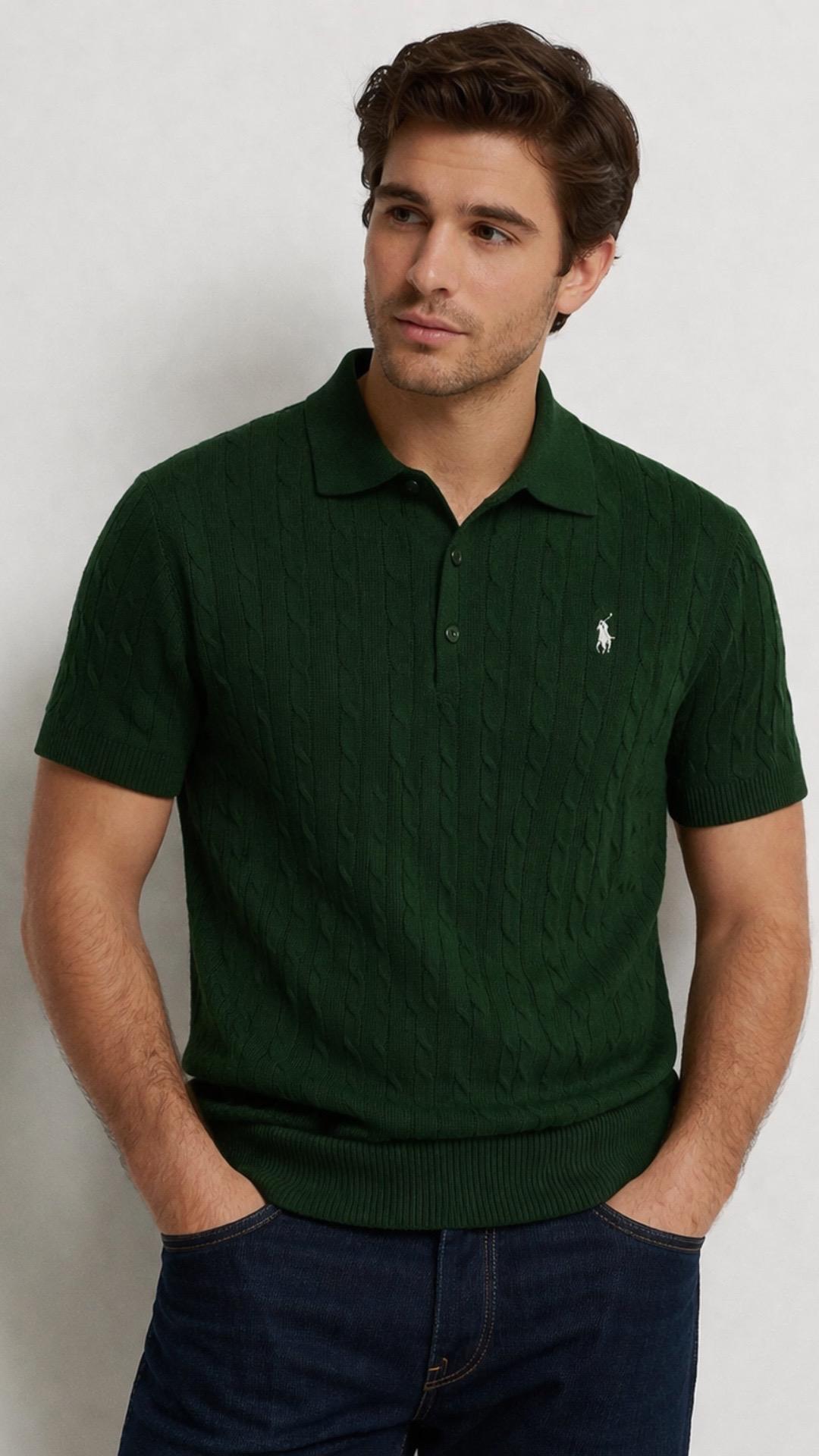 Man wearing a green polo shirt with a logo on a plain background