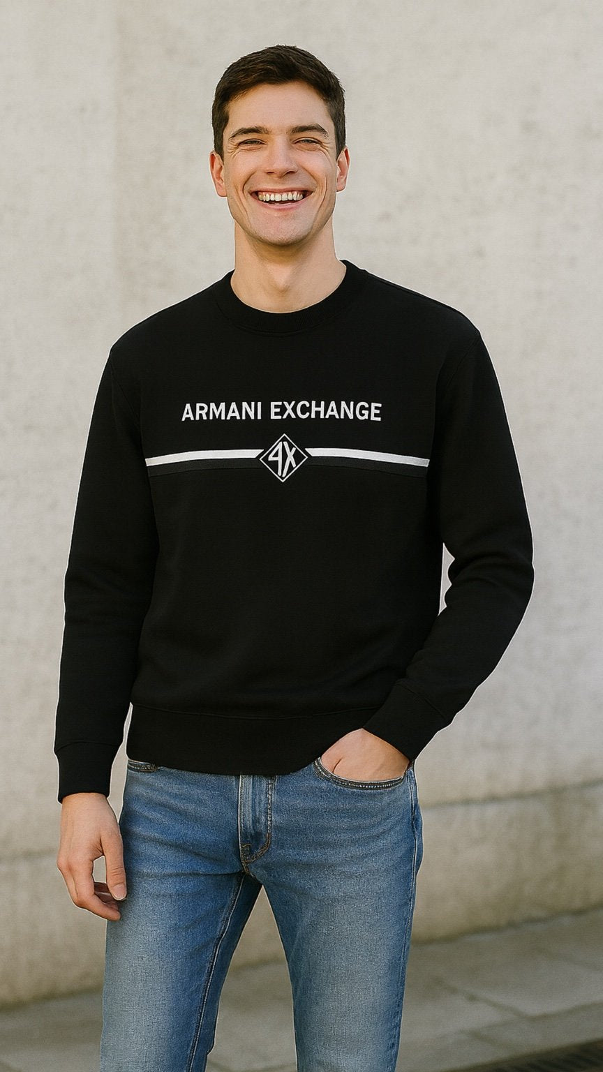Man wearing a black Armani Exchange sweatshirt against a light-colored wall.
