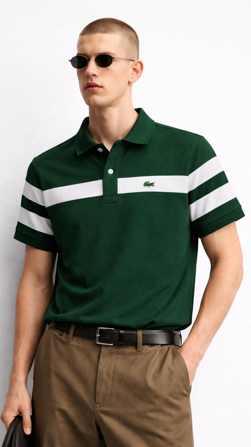 Man wearing a green polo shirt with white stripes and sunglasses on a light gray background