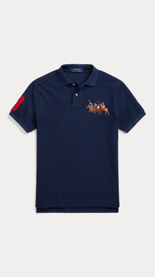 Navy polo shirt with a colorful logo on a light gray background