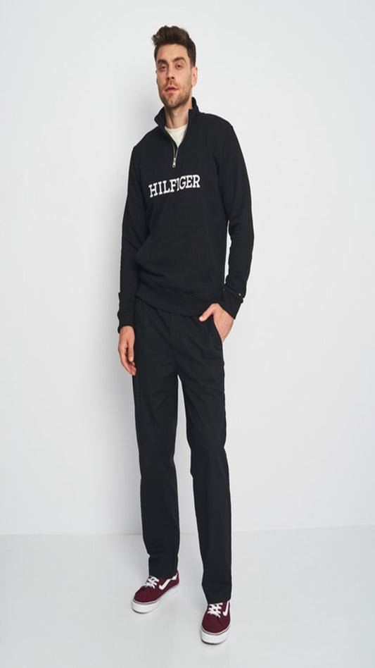 Man wearing a black Tommy Hilfiger Quarter zipper  on a white background