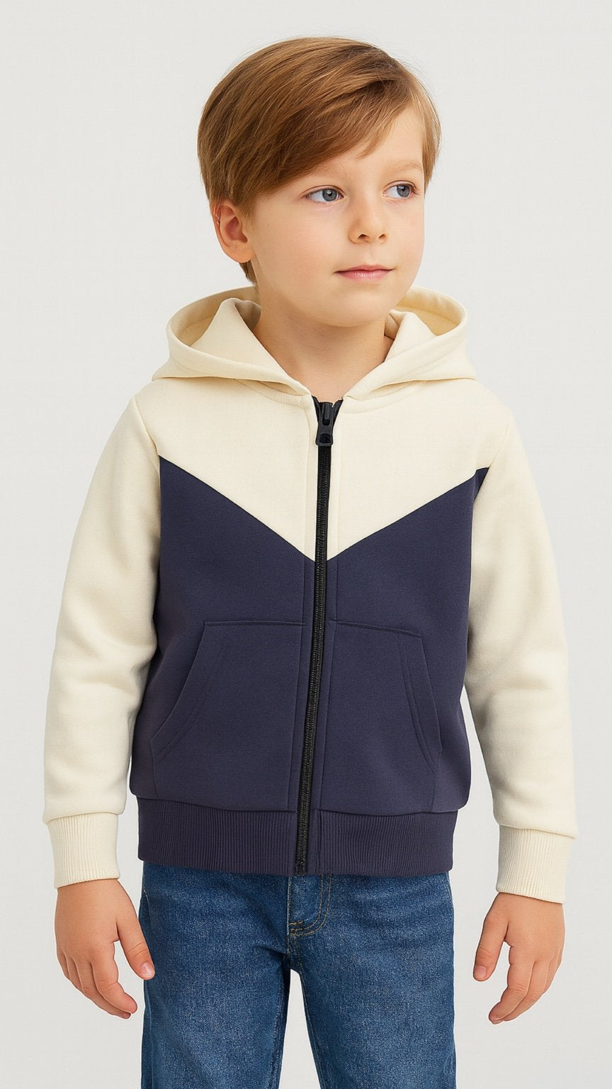 Child wearing a cream and navy color-blocked hoodie on a white background