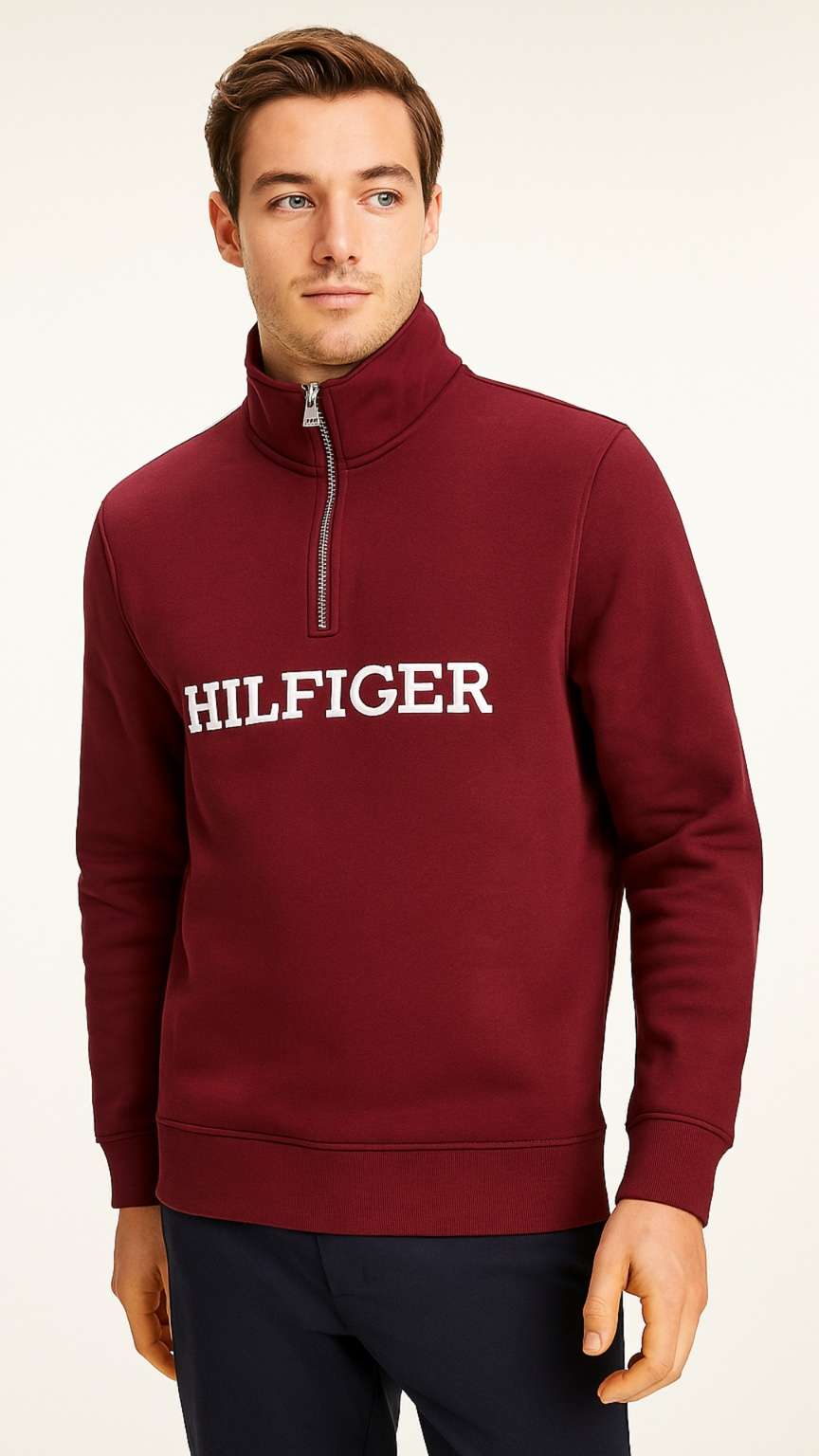 Man wearing a burgundy Tommy Hilfiger sweatshirt on a white background