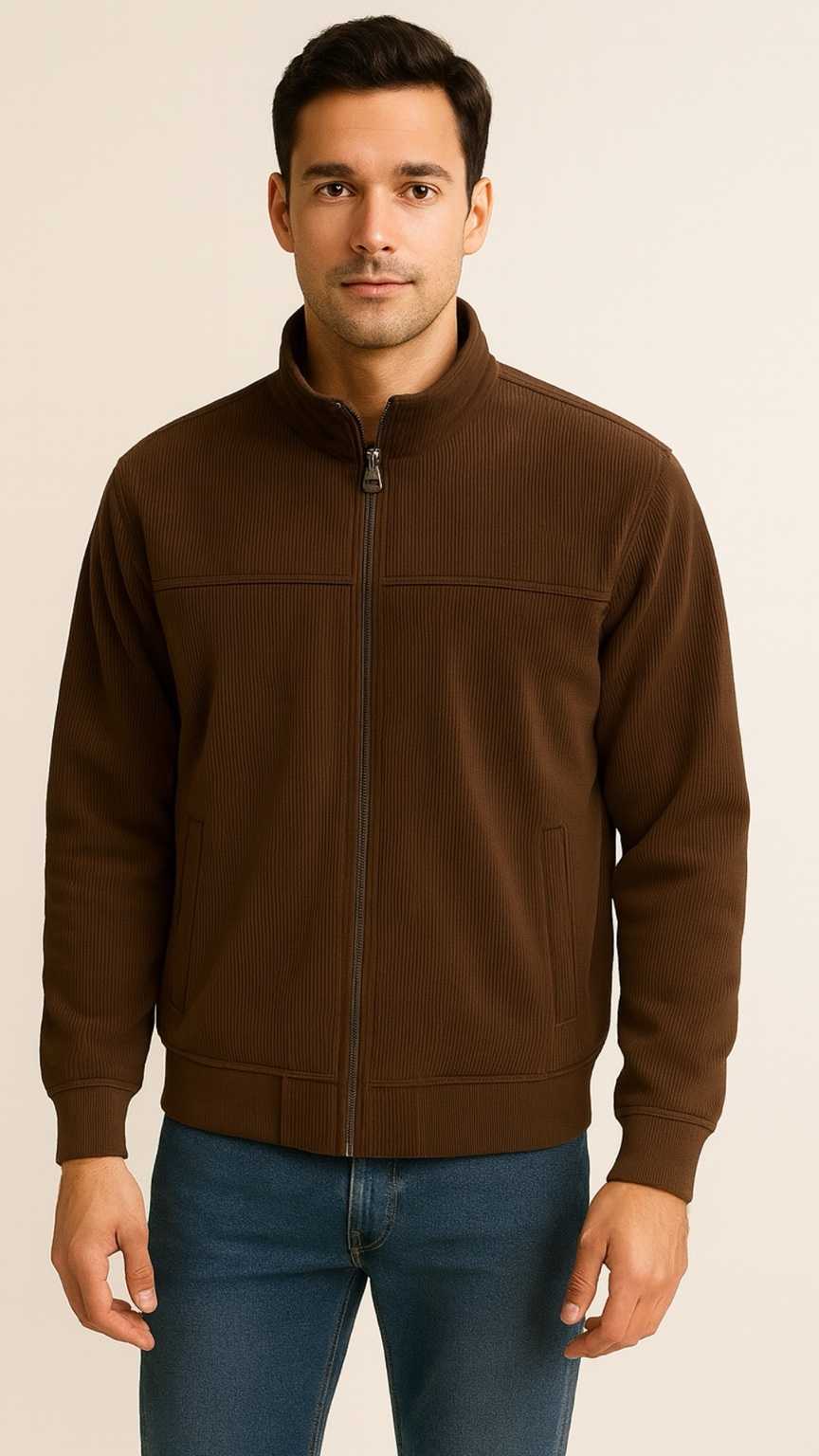 Man wearing a brown jacket and blue jeans on a beige background