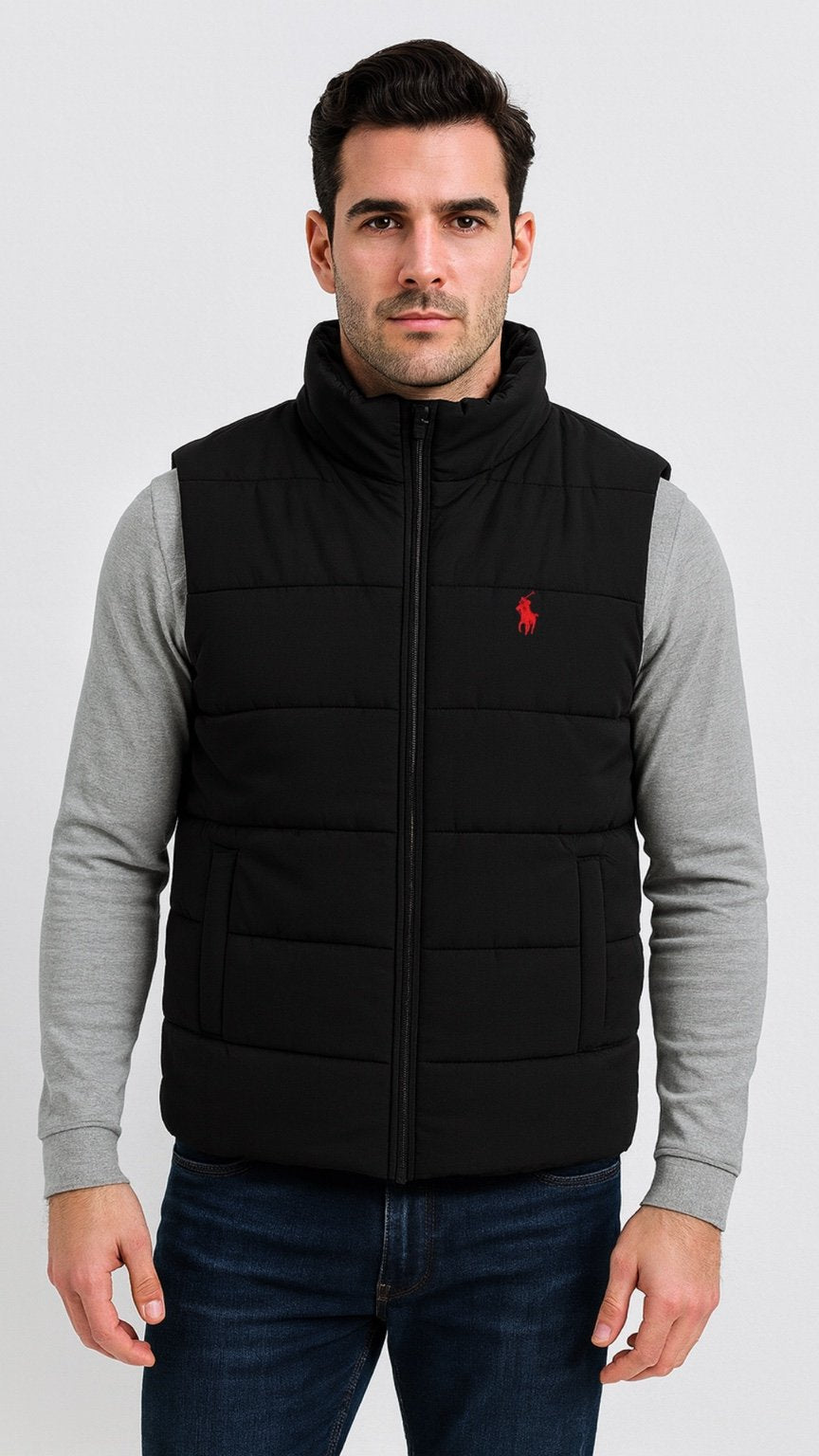 Man wearing a black puffer vest with a red logo on a white background