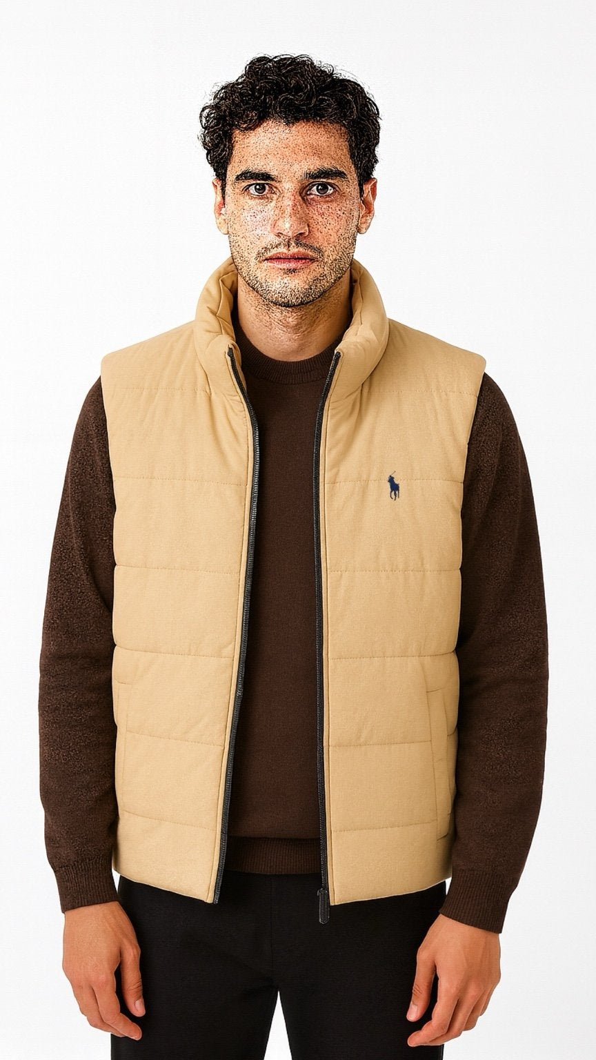 Man wearing a beige puffer vest over a brown shirt on a white background
