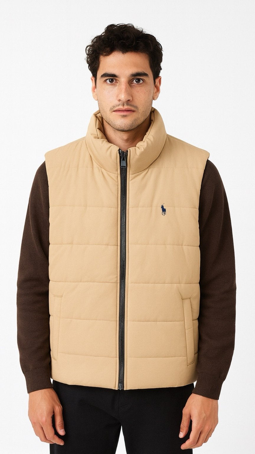 Man wearing a beige puffer vest over a brown shirt on a white background