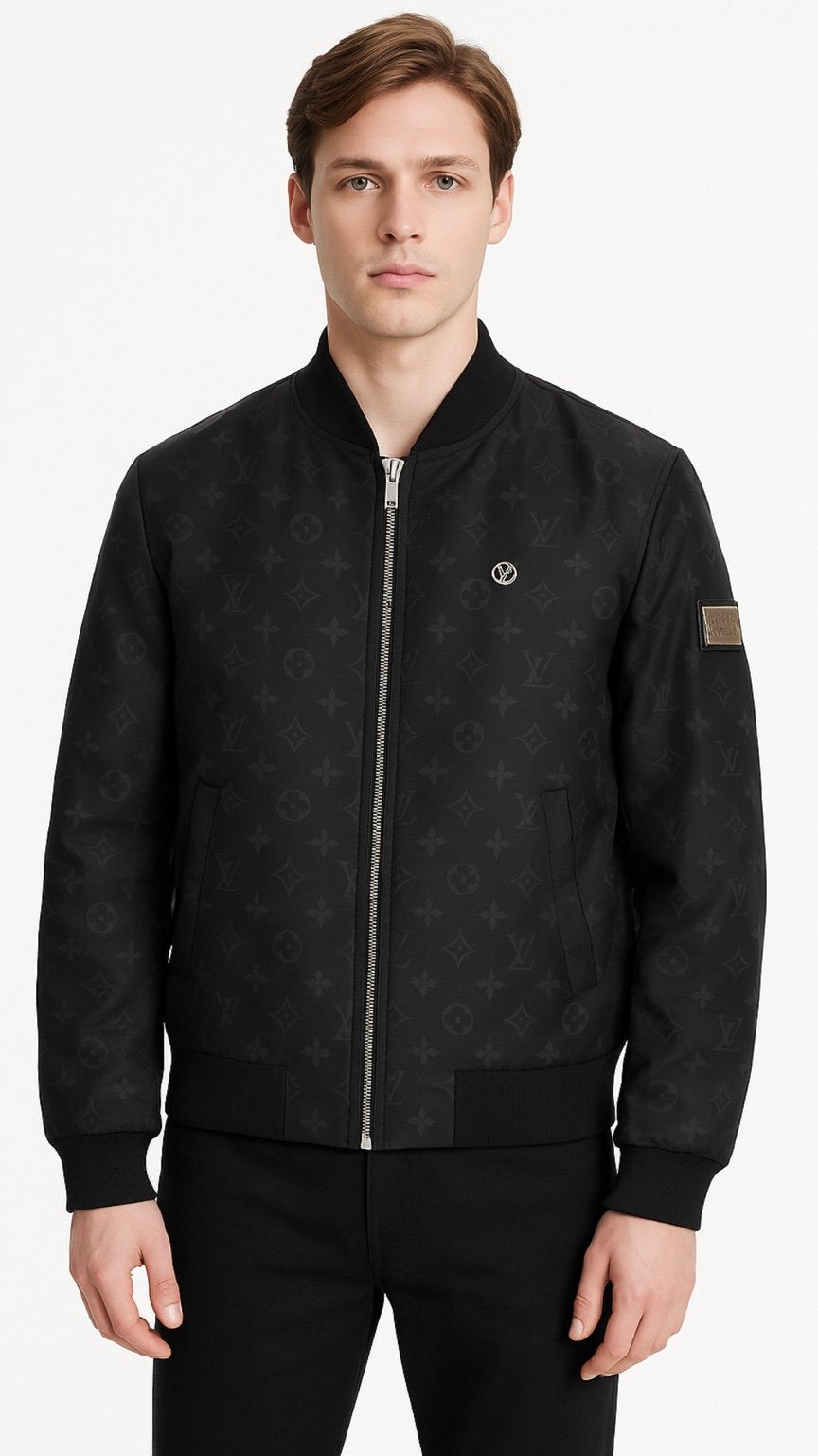 Man wearing a black bomber jacket with a brand logo on a white background