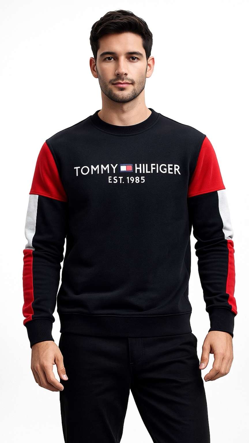 Man wearing a Tommy Hilfiger black and red sweatshirt on a white background